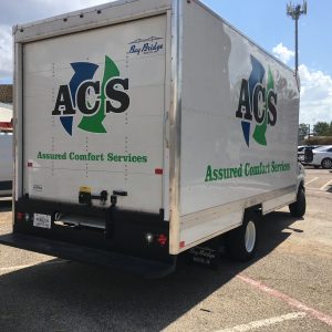 Box truck three color logo wrap with Assured Comfort Services logo design. Back door and passenger side.