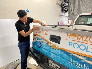 Wrapping tailgate digitally printed vinyl for truck wrap.